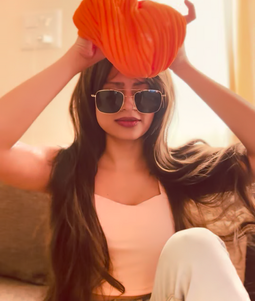 Sunday Wig on model – Brown Wavy Synthetic Hair

FLAWNT-IT Wig with Orange Turban – Styled Shot

Long synthetic wig for women – Indian skin tone
